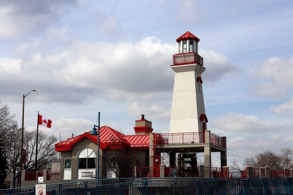 Working lighthouse amid scenic surroundings with harbour and Credit River views