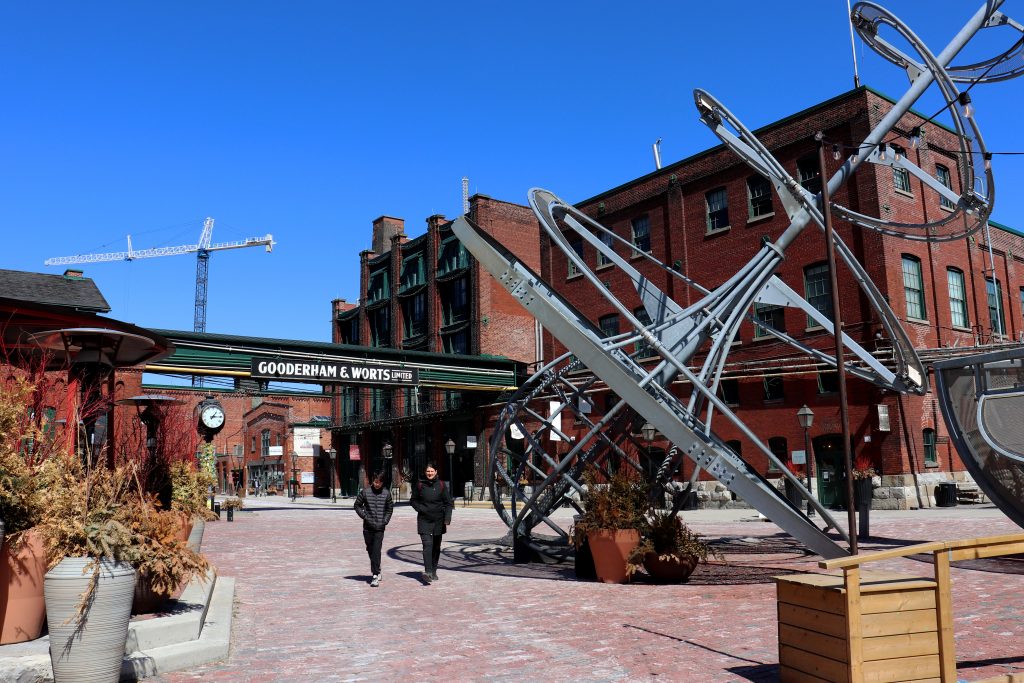 People walking around Toronto's popular Distillery District 