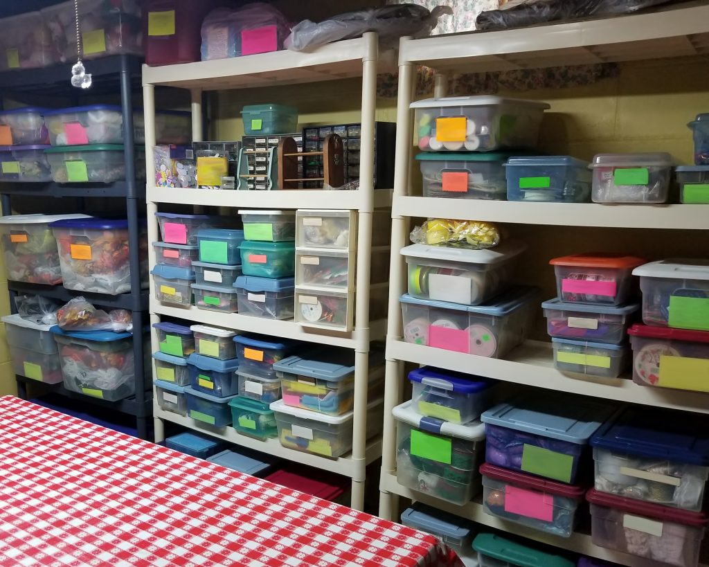 A well-organized  basement storage space using shelving and plastic containers