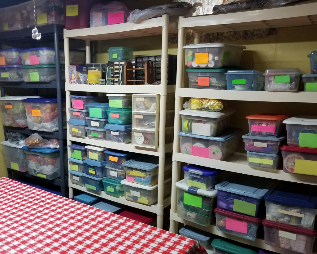 A well-organized basement storage space using shelving and plastic containers