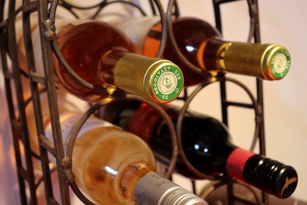 A variety of different wines on a storage rack 