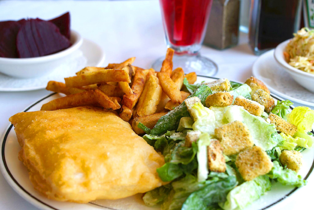 Fried halibut and French fries with a Caesar salad