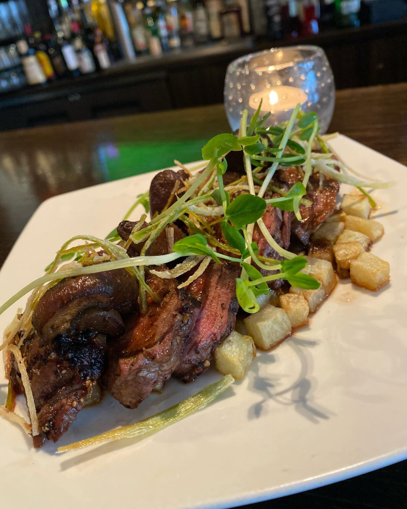 Grilled 8oz Beef Tenderloin with buttered potatoes, leek crisps, and crimini mushrooms