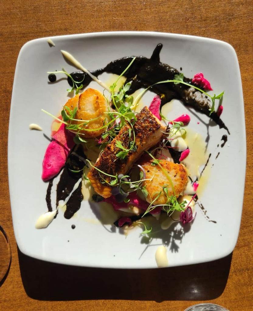 Salmon and Scallops, black tomato sauce, and microgreens