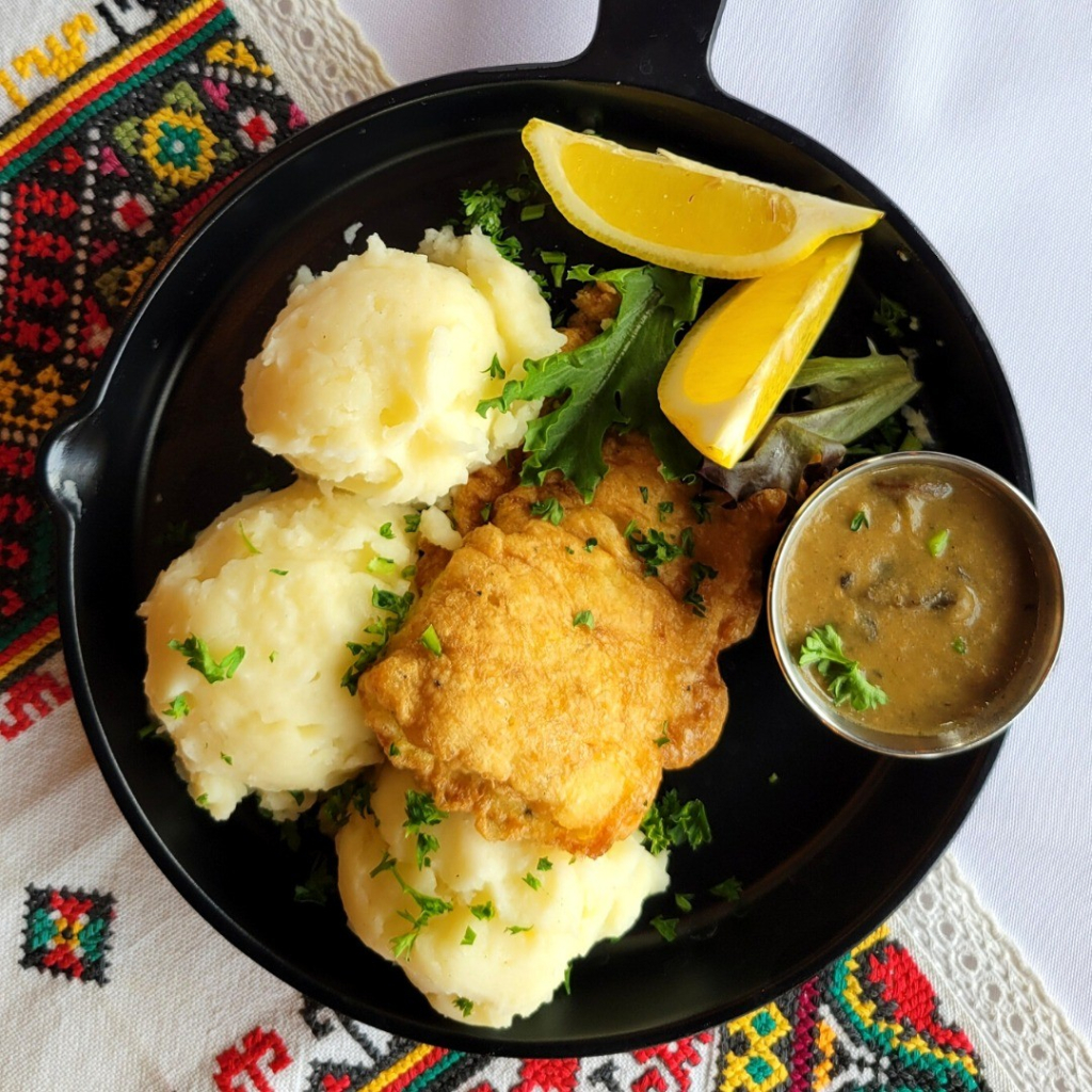 Breaded bass with mashed potatoes and gravy