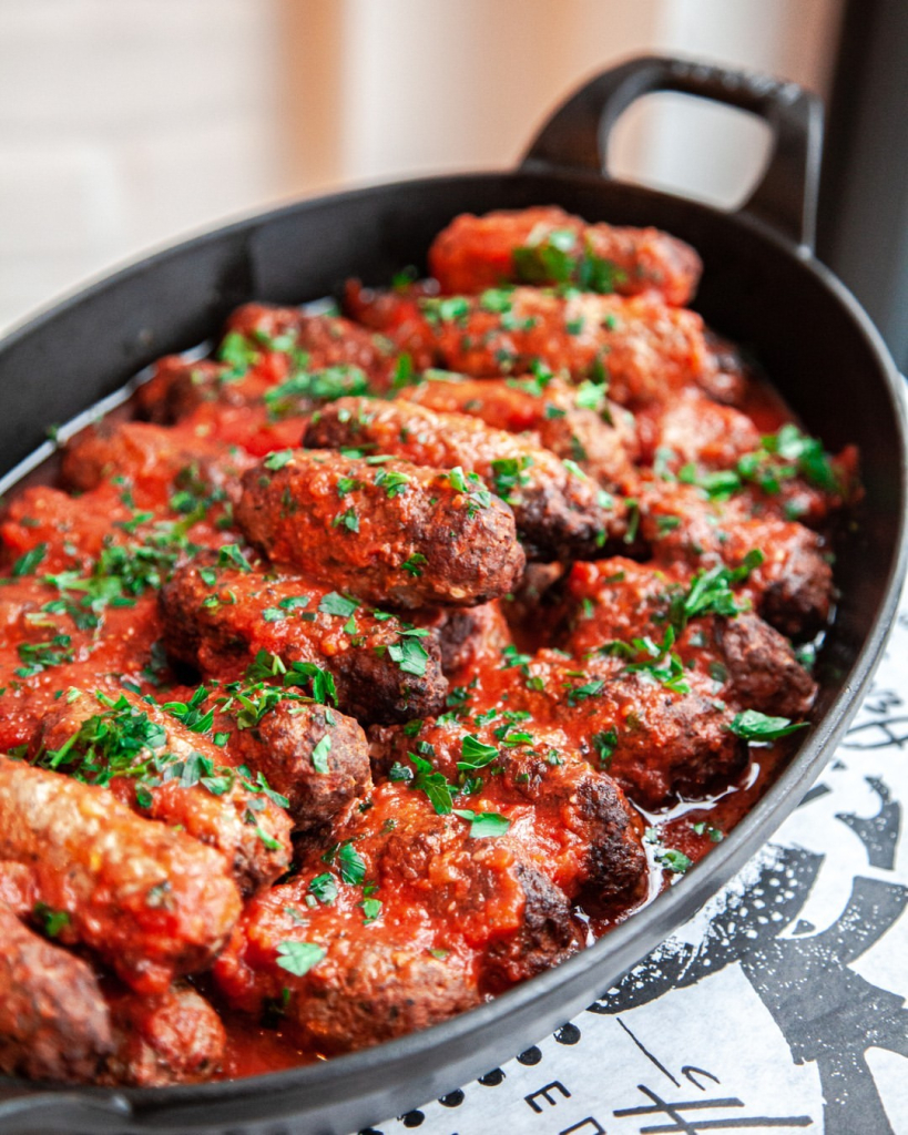 Soutzoukakia, seasoned beef meatballs braised in a bright tomato sauce